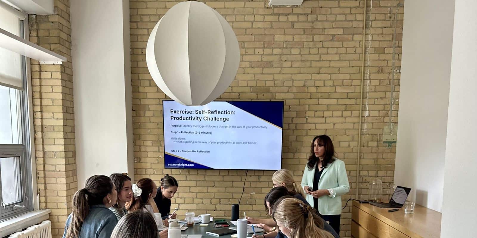 Suzanne Knight leading a productivity workshop for a team of leaders