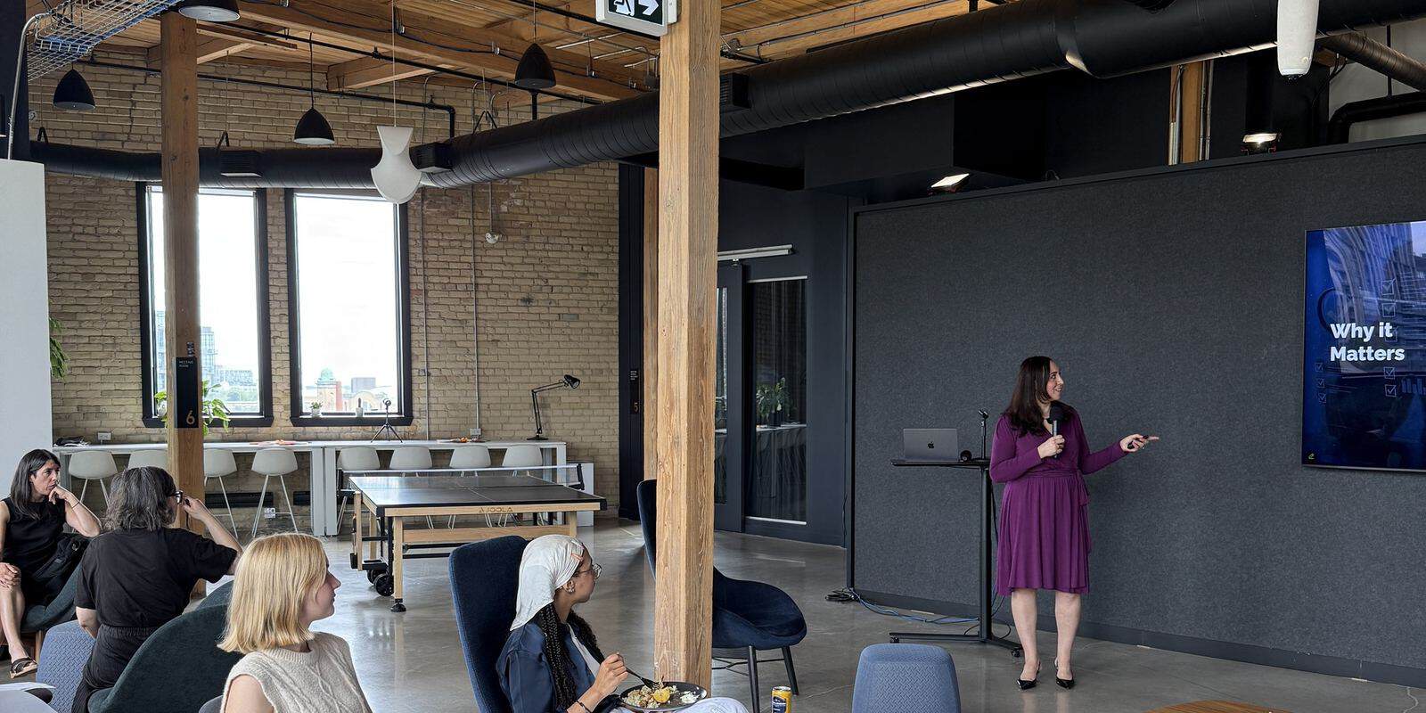 Suzanne Knight speaking to a room of leaders in a Toronto loft venue